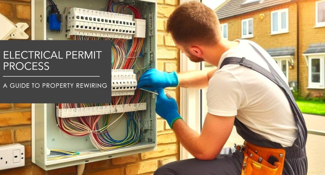 An electrician working on a residential property's electrical panel during a rewiring project
